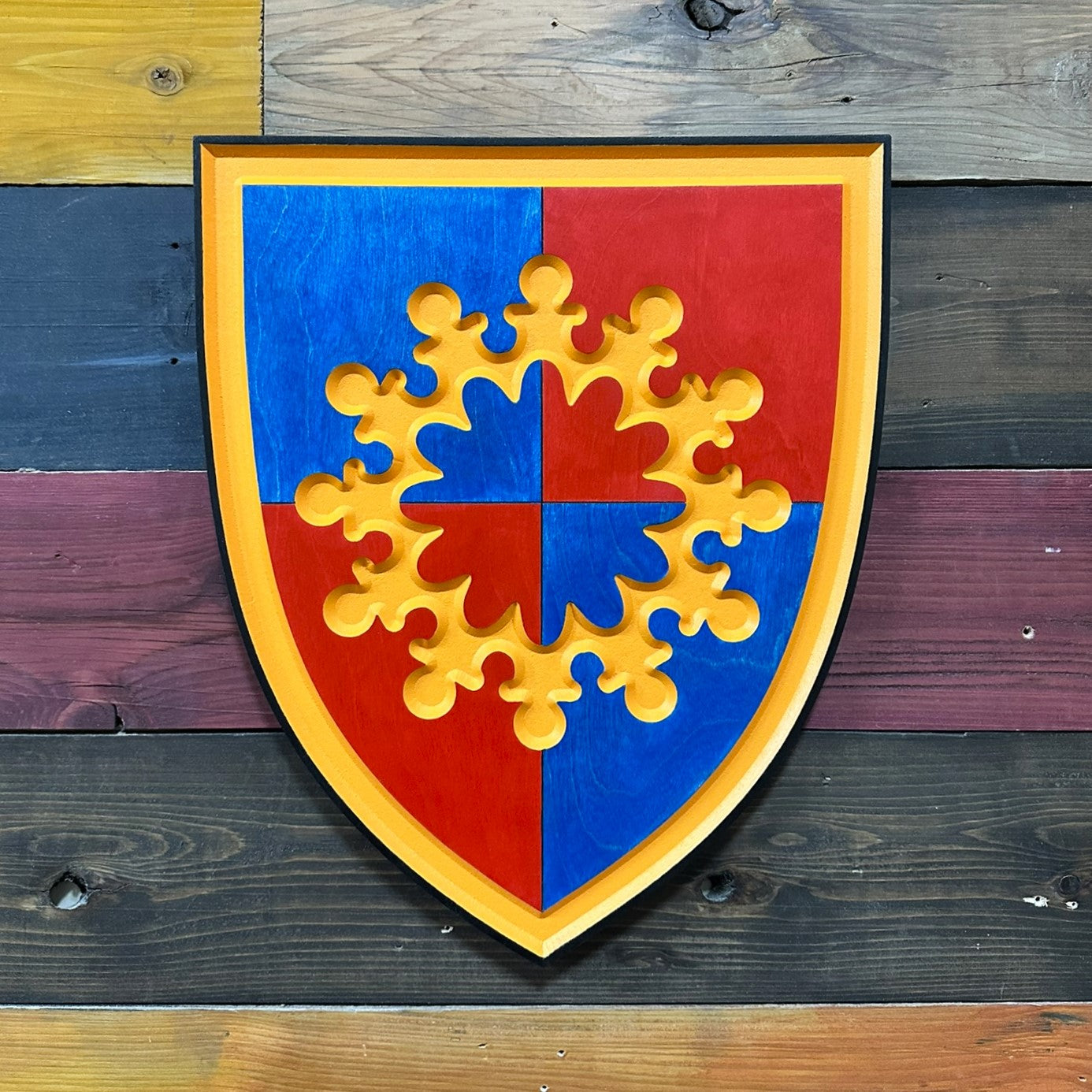 Close up detail of 149th Maneuver Enhancement Brigade carved wood shield showing gold central emblem