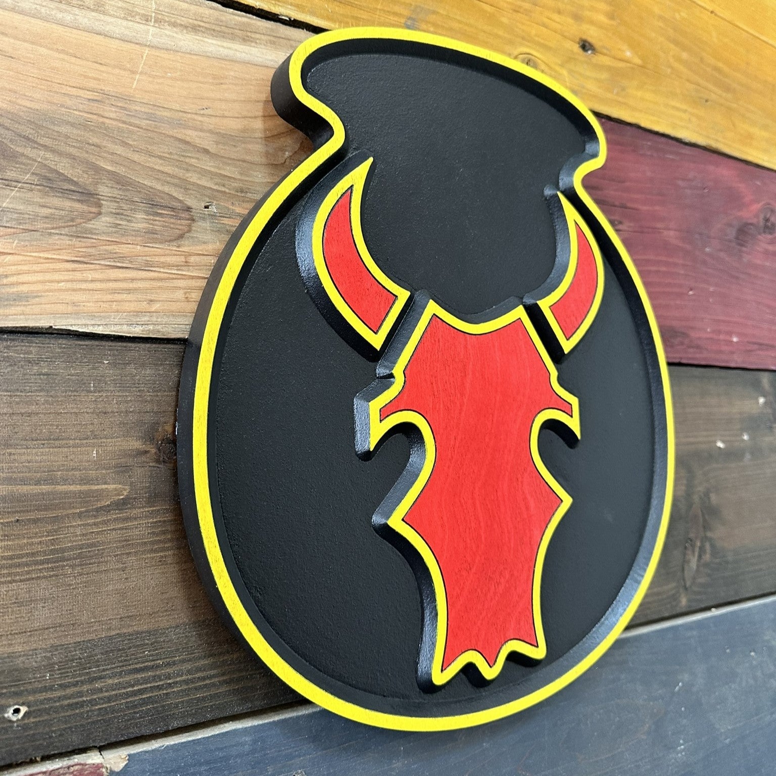 angled view showing depth of carved 34th Infantry Division Red Bull CSIB wood sign
