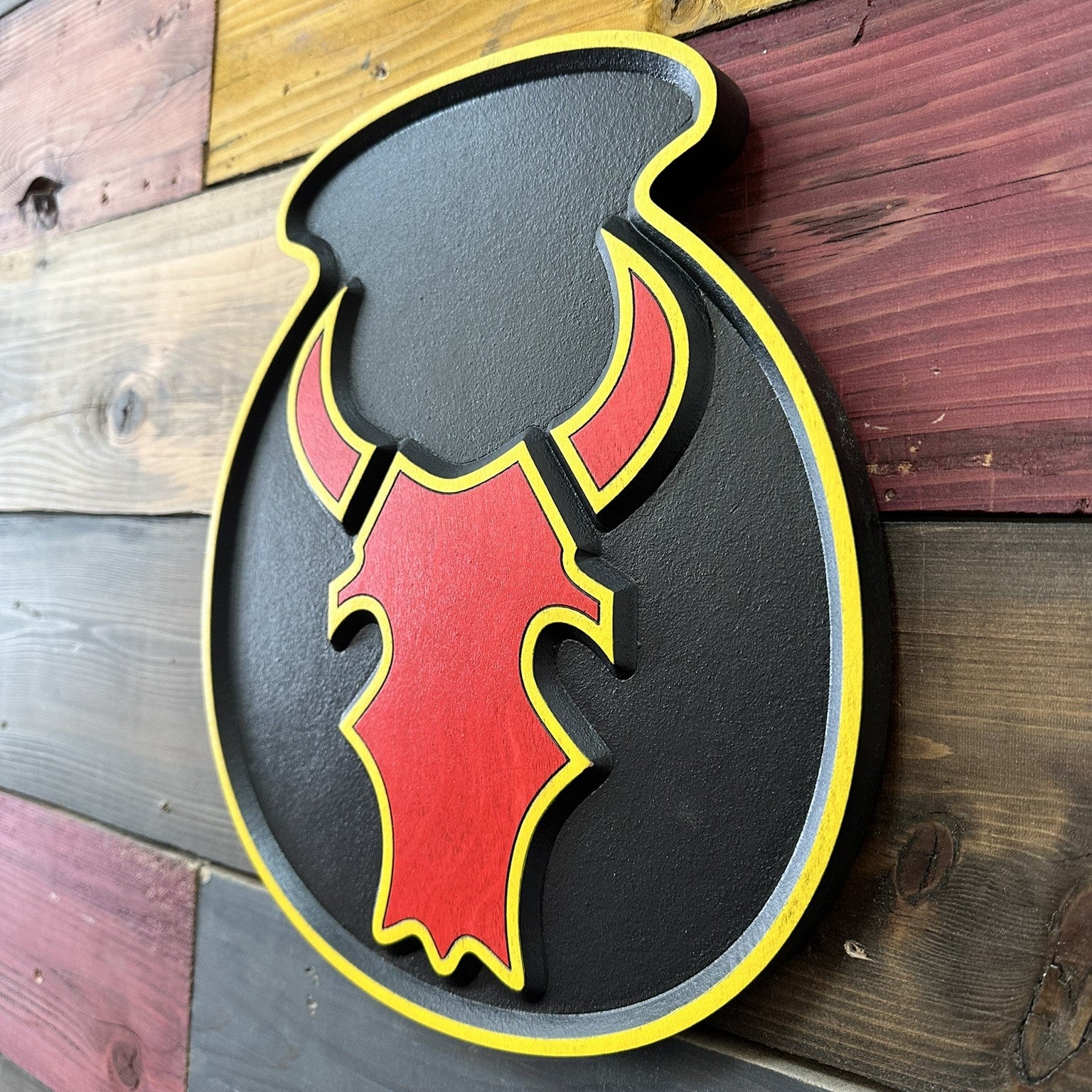 side profile showing dimensional carving of 34th Infantry Division Red Bull insignia wood sign