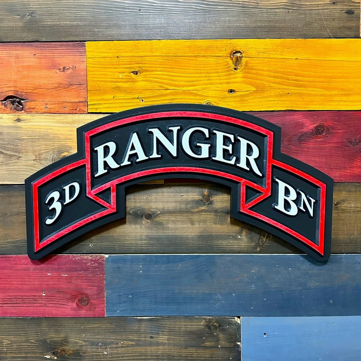 Close up detail of 3rd Ranger Battalion carved wood Ranger scroll showing raised lettering and red border