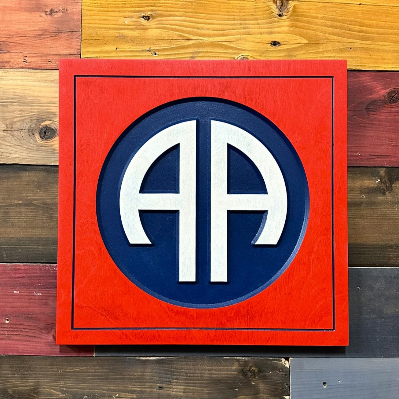Close up detail of 82nd Airborne Division AA insignia carved wood wall sign