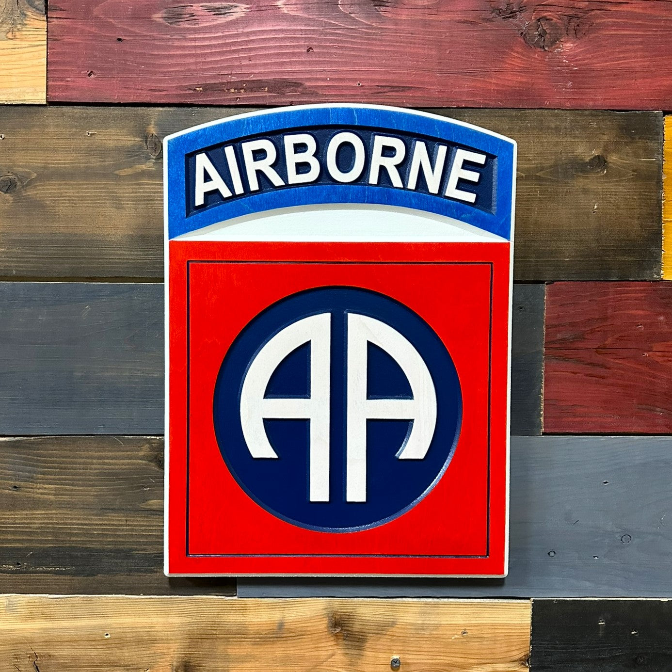 Close up detail of 82nd Airborne Division AA insignia and Airborne tab carved wood wall sign
