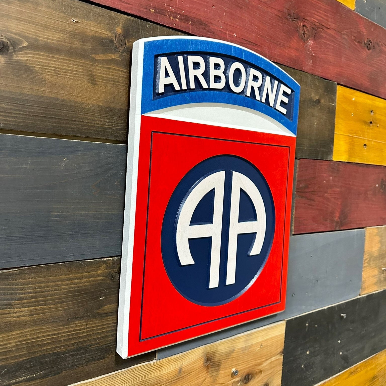 Featuring the iconic red square, blue circle, and white AA insignia topped with the Airborne tab, this piece represents one of the most recognized divisions in the United States Army.