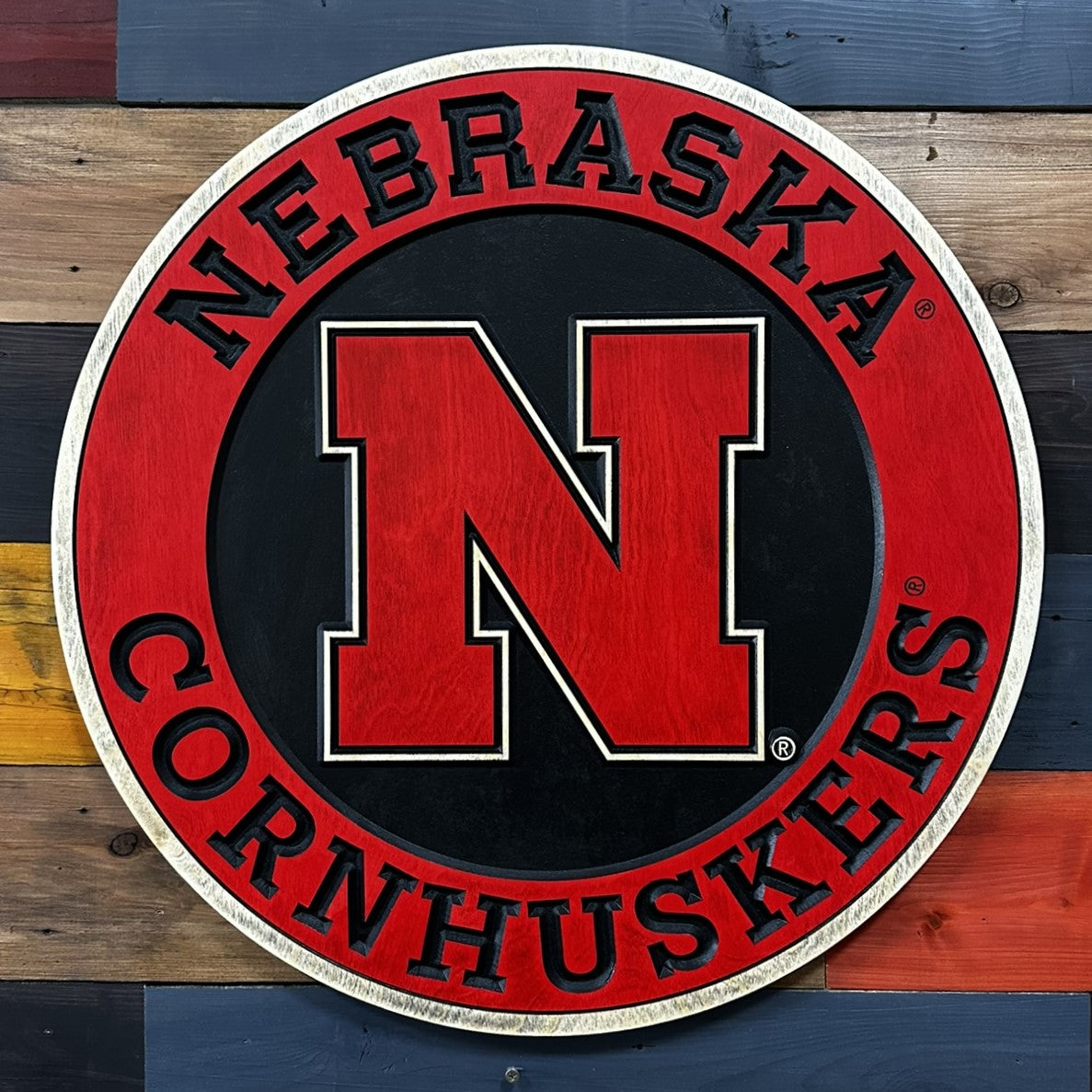 Nebraska Huskers signage logo on a wooden background