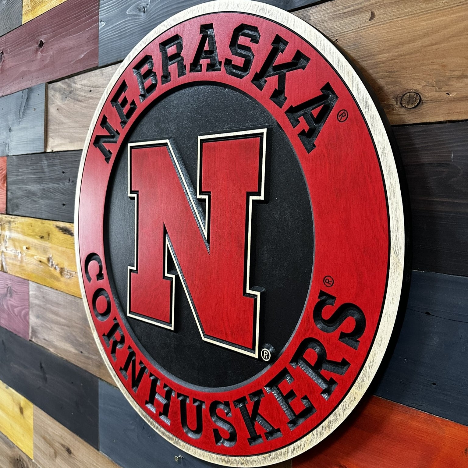 Nebraska Cornhuskers logo on a wooden background