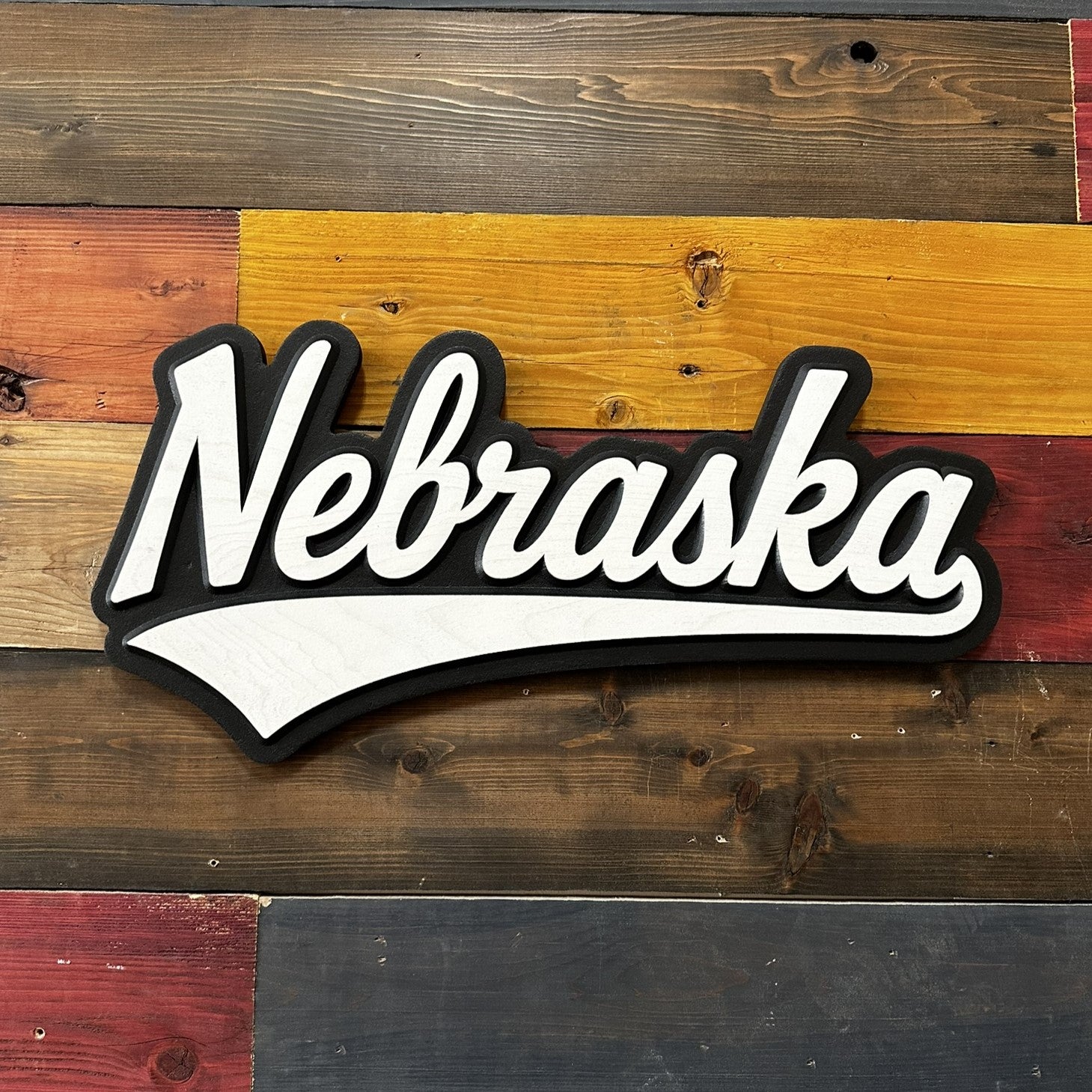 Wooden sign with 'Nebraska' text on a rustic wooden background