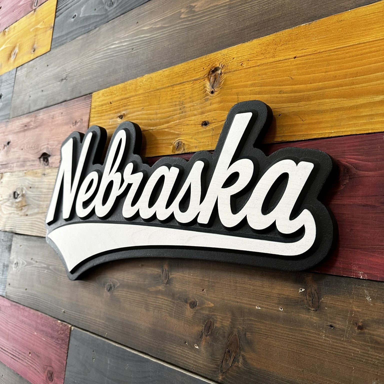 Nebraska sign on a wooden wall with horizontal planks.