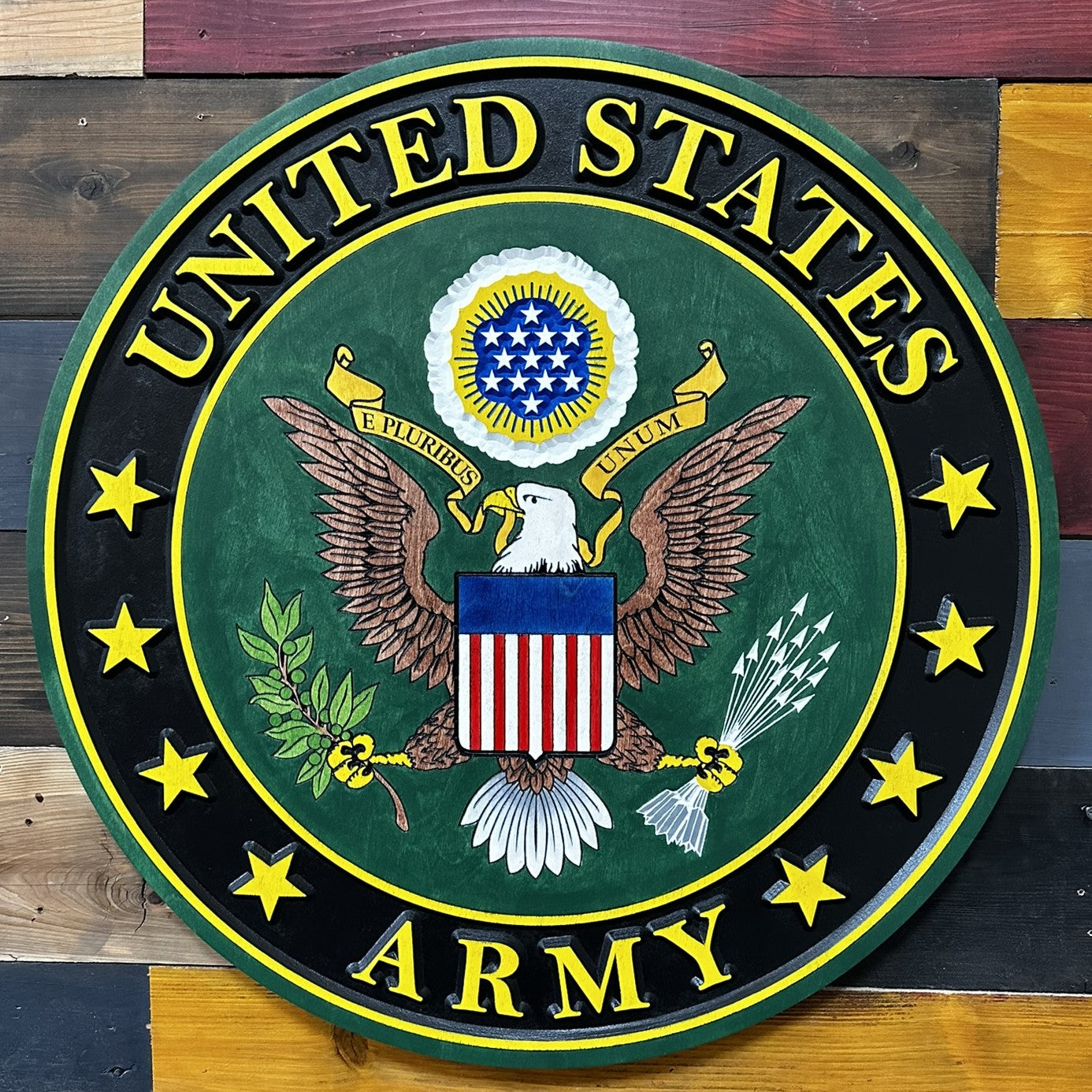 Close-up detail of CNC carved United States Army emblem showing deep carving and hand-painted finish on engineered wood
