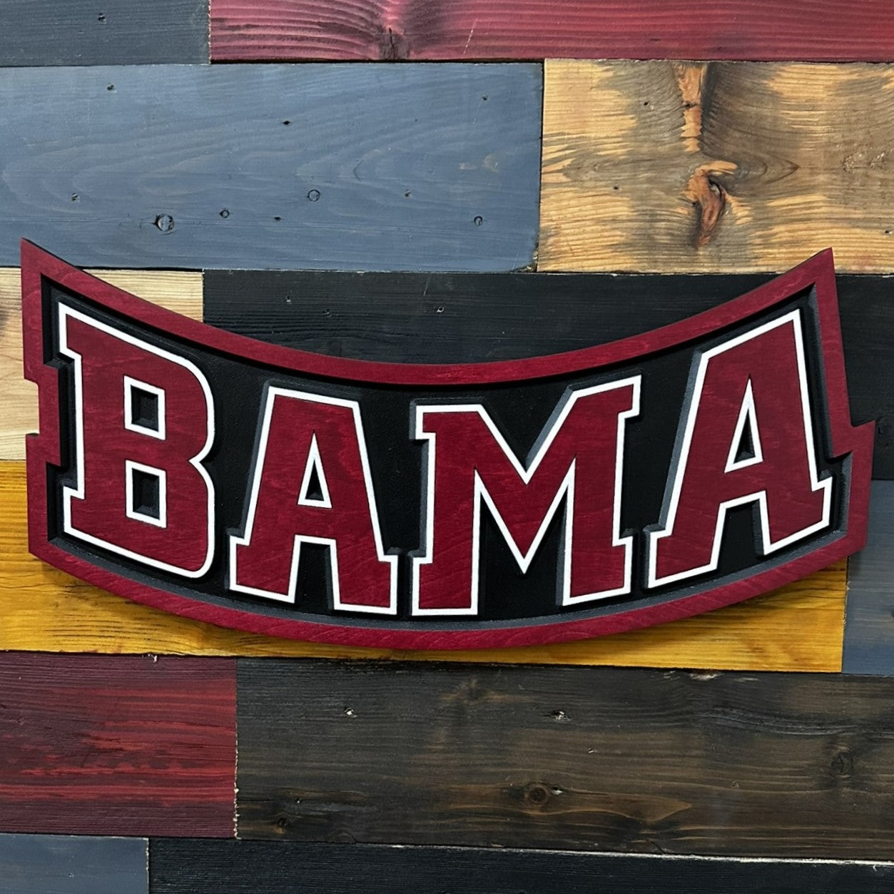 Close-up of carved Alabama Crimson Tide BAMA wood sign detail