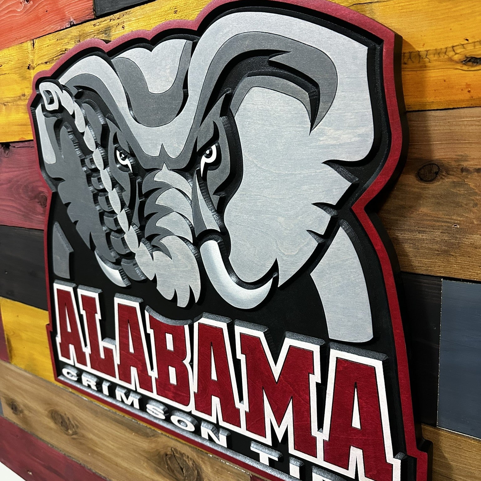 Detail view of carved Alabama elephant head logo wood sign
