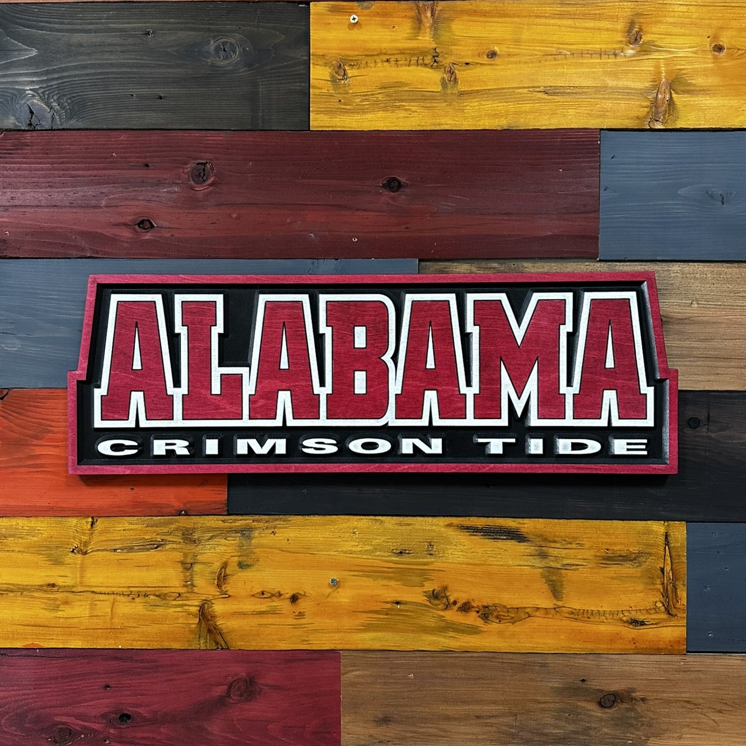 Close-up of carved Alabama Crimson Tide wood sign detail
