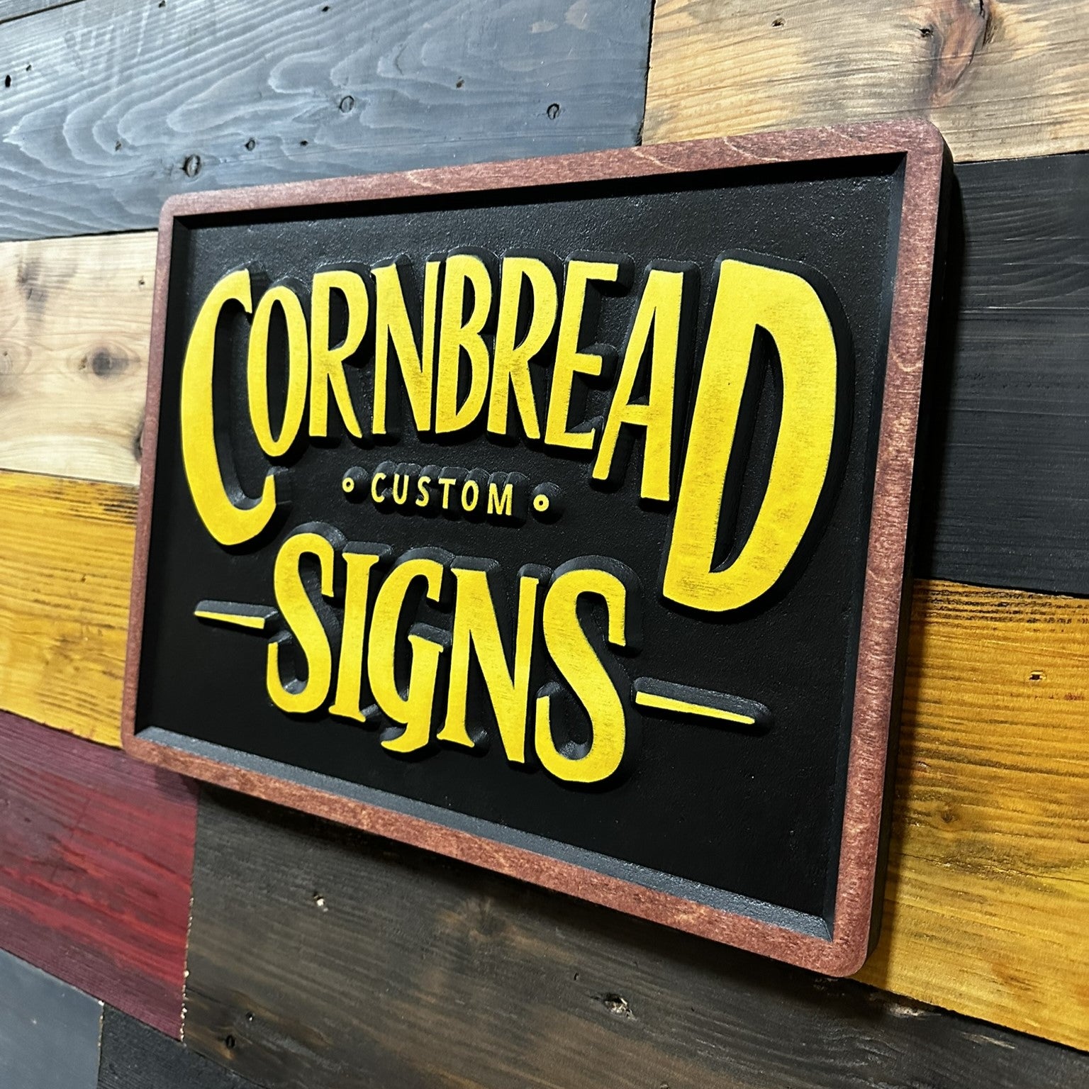 Cornbread Custom Signs yellow and black shop wall art with stained wood frame