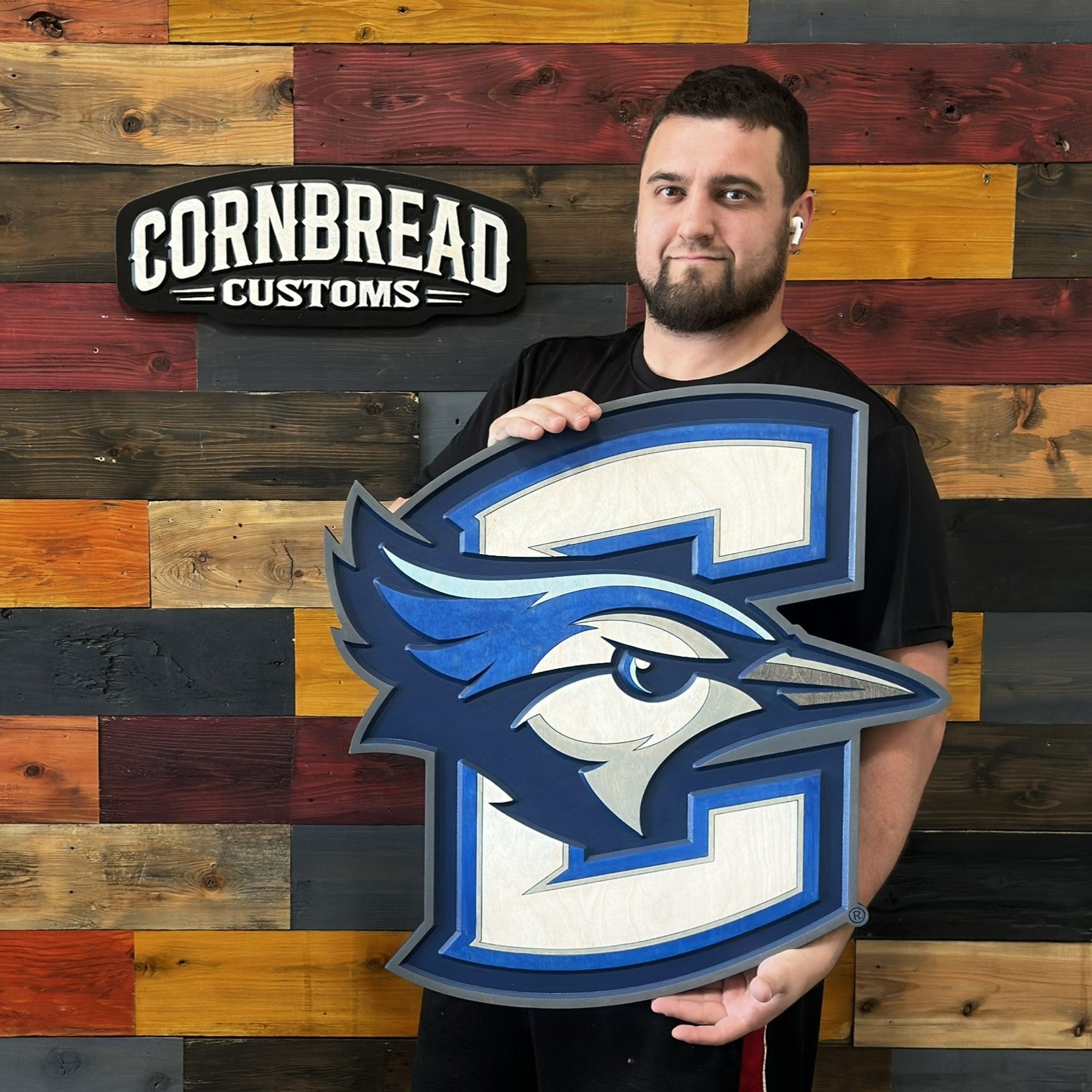Creighton Bluejays 3D wood wall sign being held for size reference