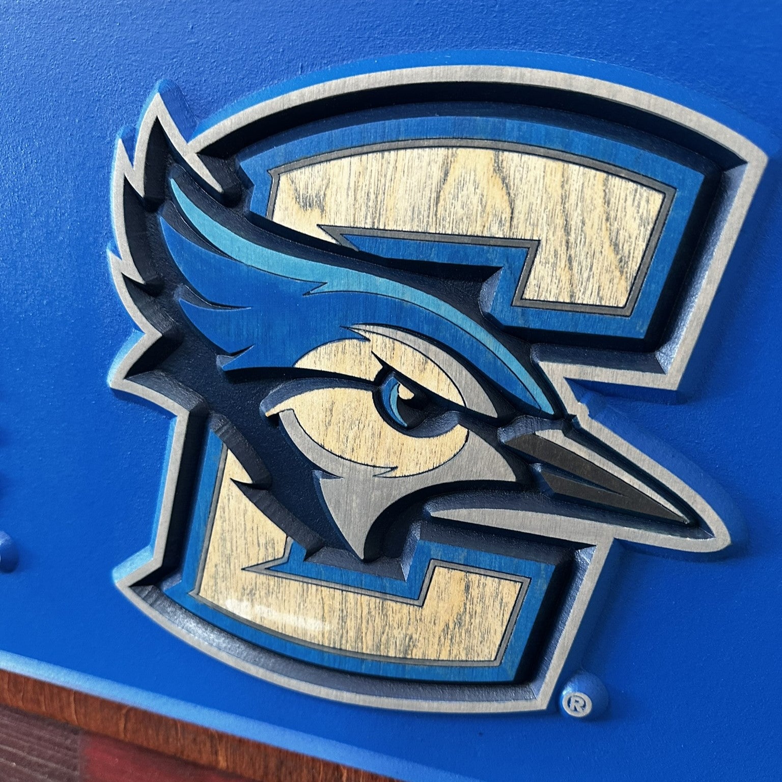 Detail view of carved Creighton University horizontal wood sign