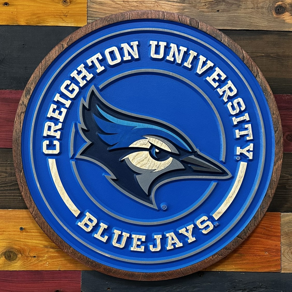 Creighton University Bluejays logo on a wooden background