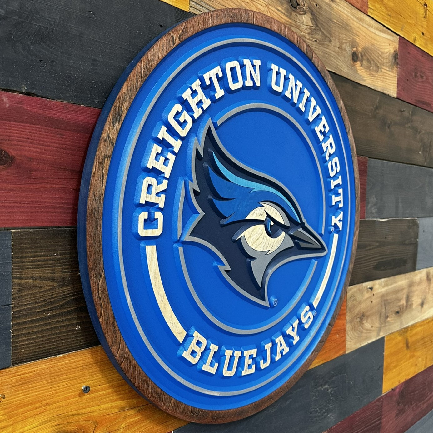 Creighton University Bluejays logo on a wooden background