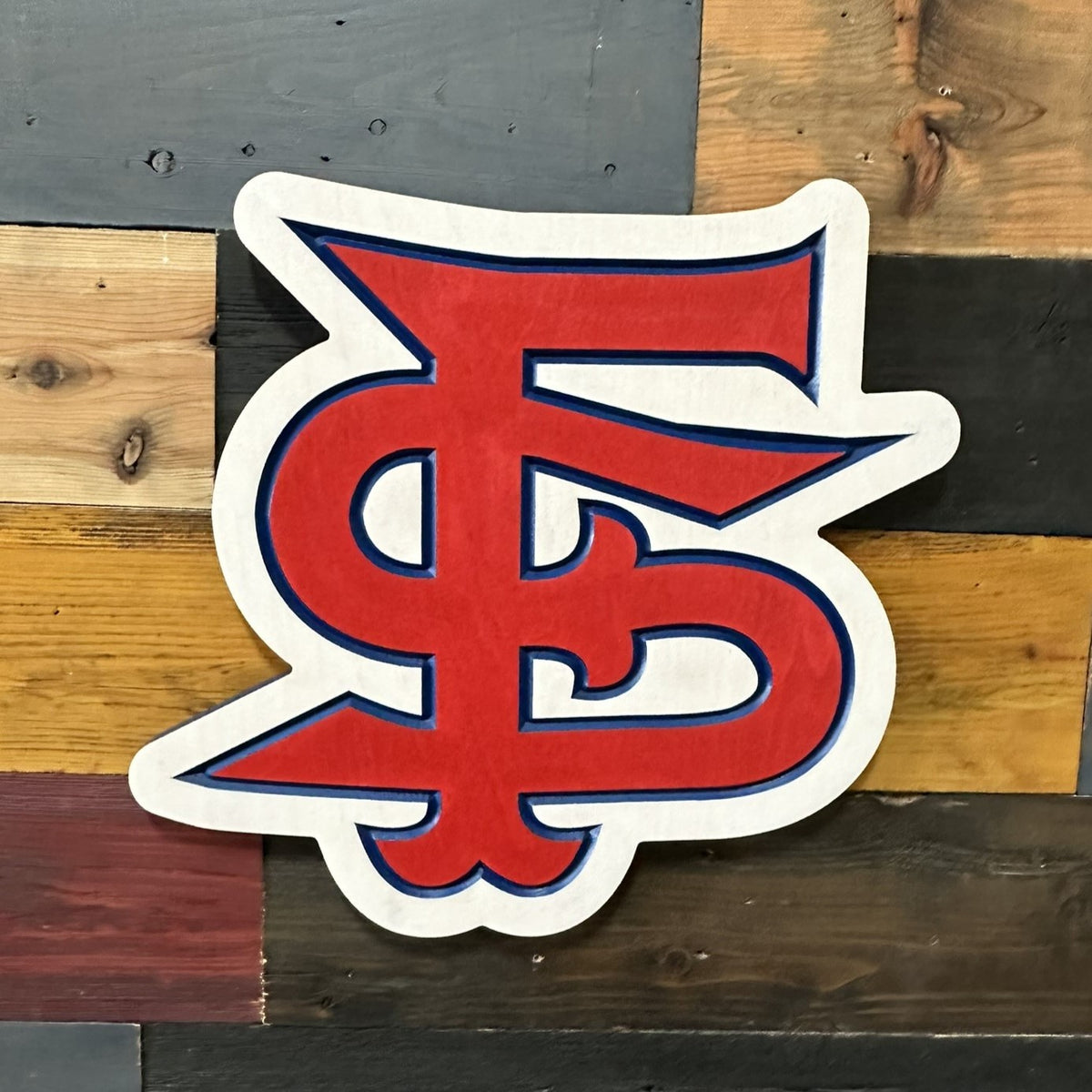 Close-up of CNC carved Fresno State FS logo with hand-painted red and blue detailing