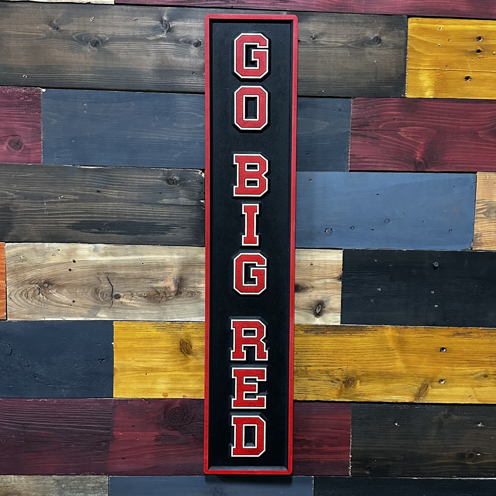 Close-up of carved Go Big Red Husker sports wood sign detail