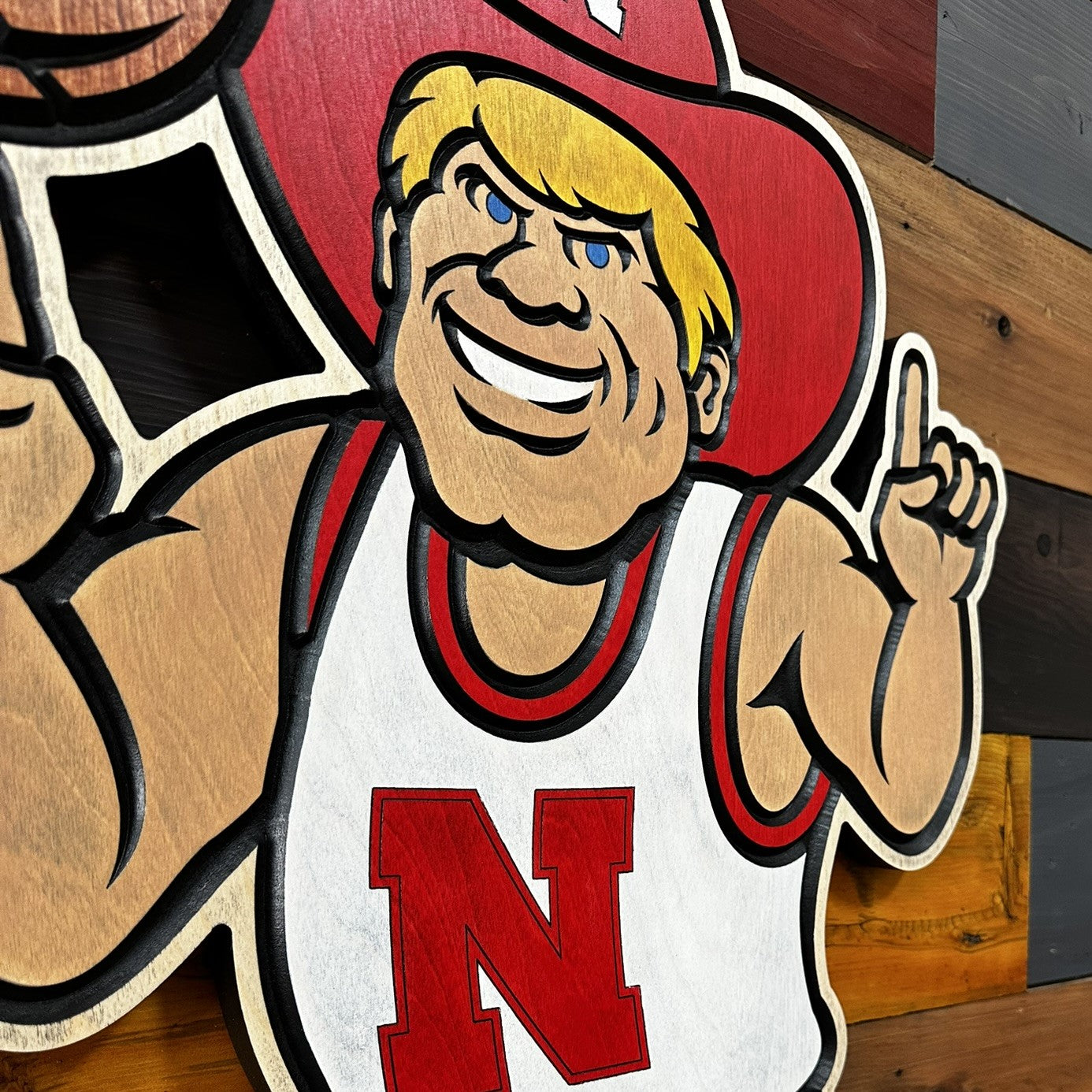 Angled view of Herbie Husker basketball wood sign