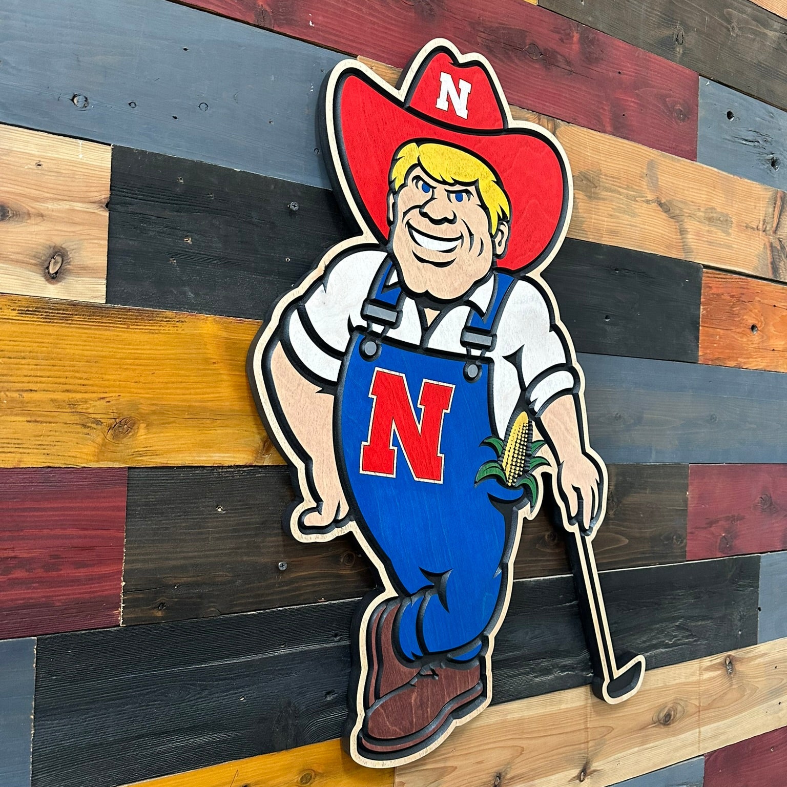 Handcrafted Herbie Husker golf wall art with carved wood details and Nebraska colors