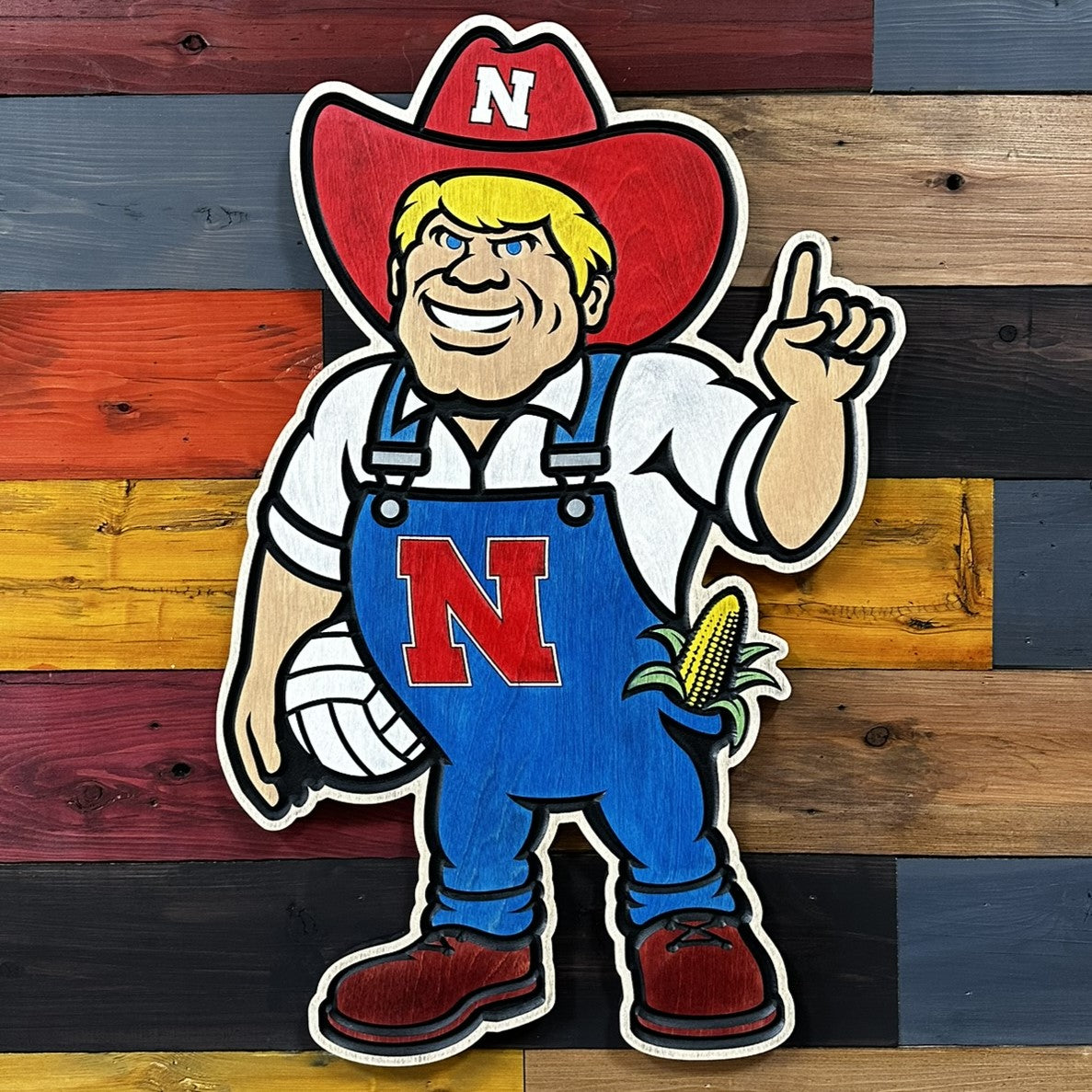 Close-up of carved Herbie Husker volleyball wood wall art detail