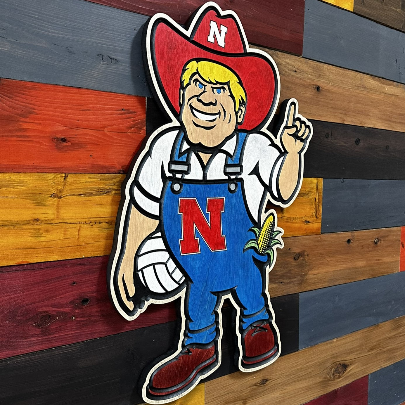 Herbie Husker volleyball wood wall art displayed on wall