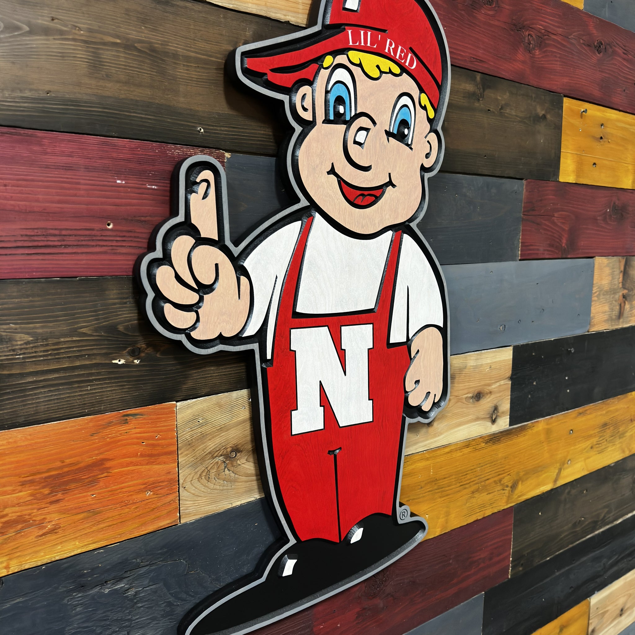 Angled view of Huskers Little Red wood sign