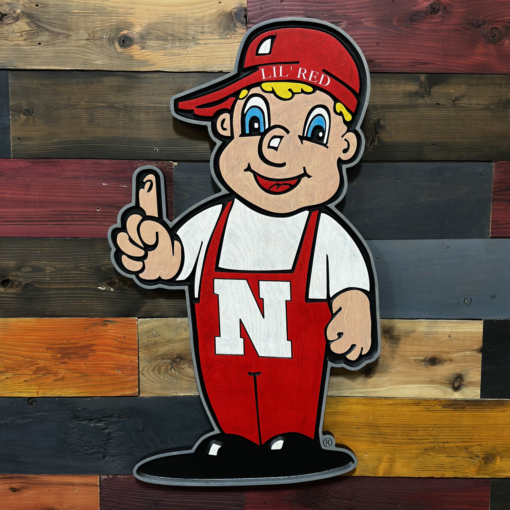 Close-up of carved Huskers Little Red wood sign detail