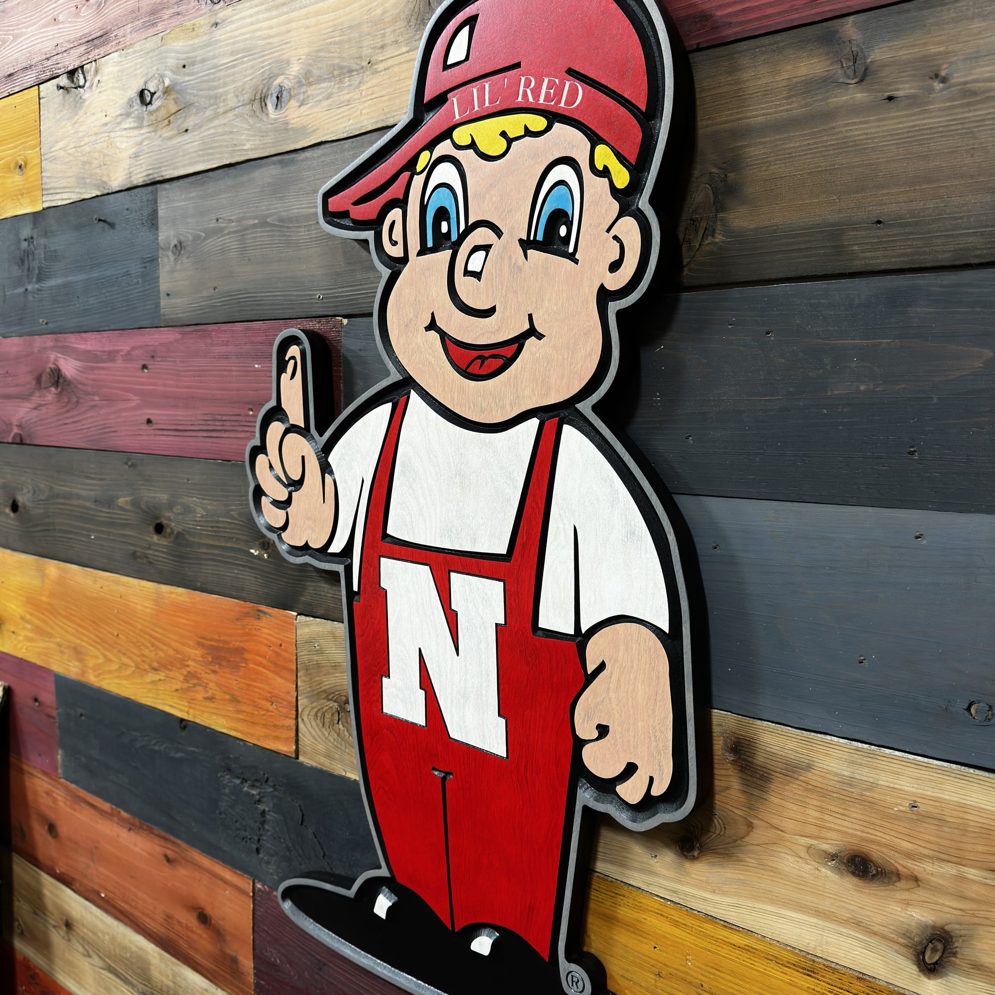 Huskers Little Red wood sign displayed on wall