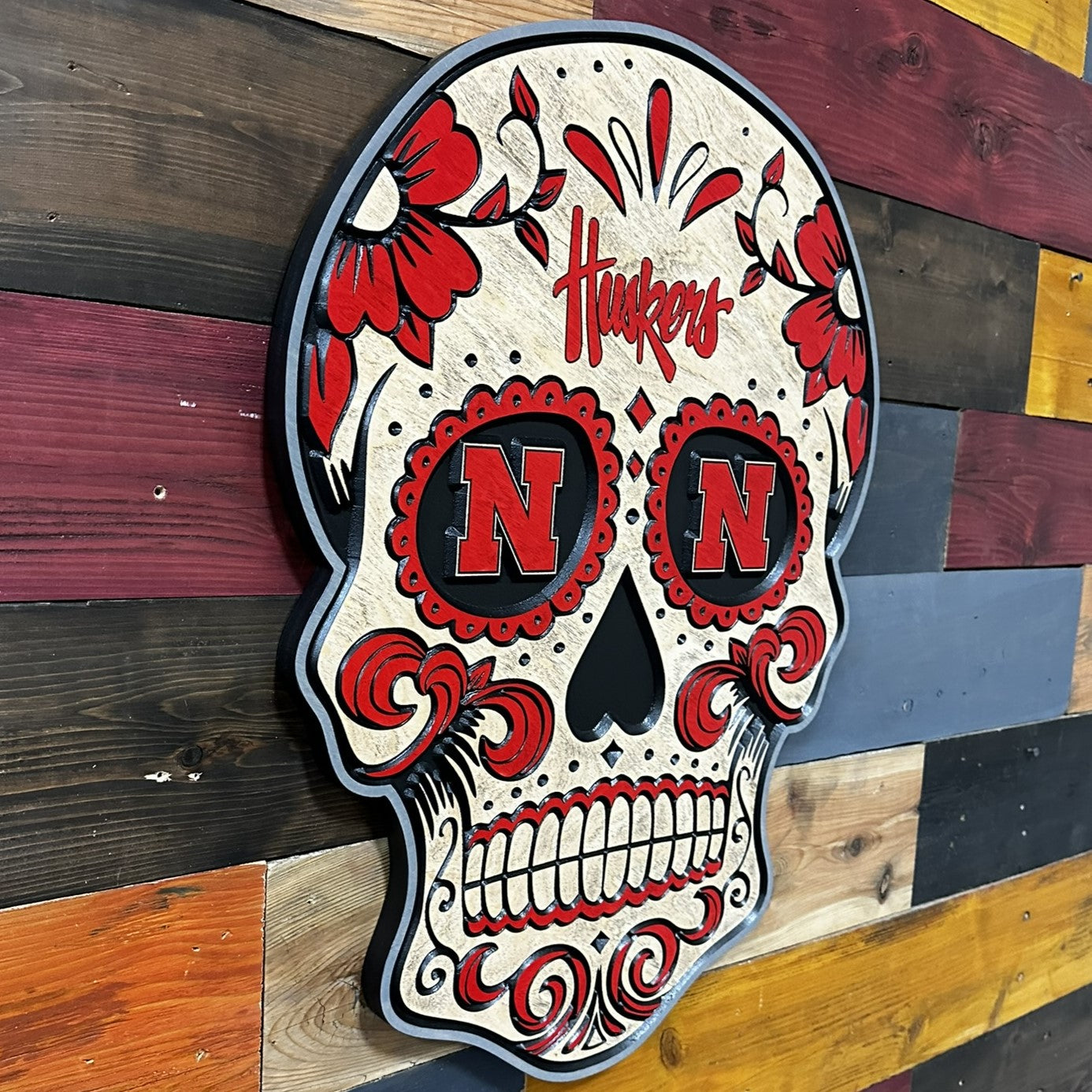 Angled view of Huskers sugar skull wood sign
