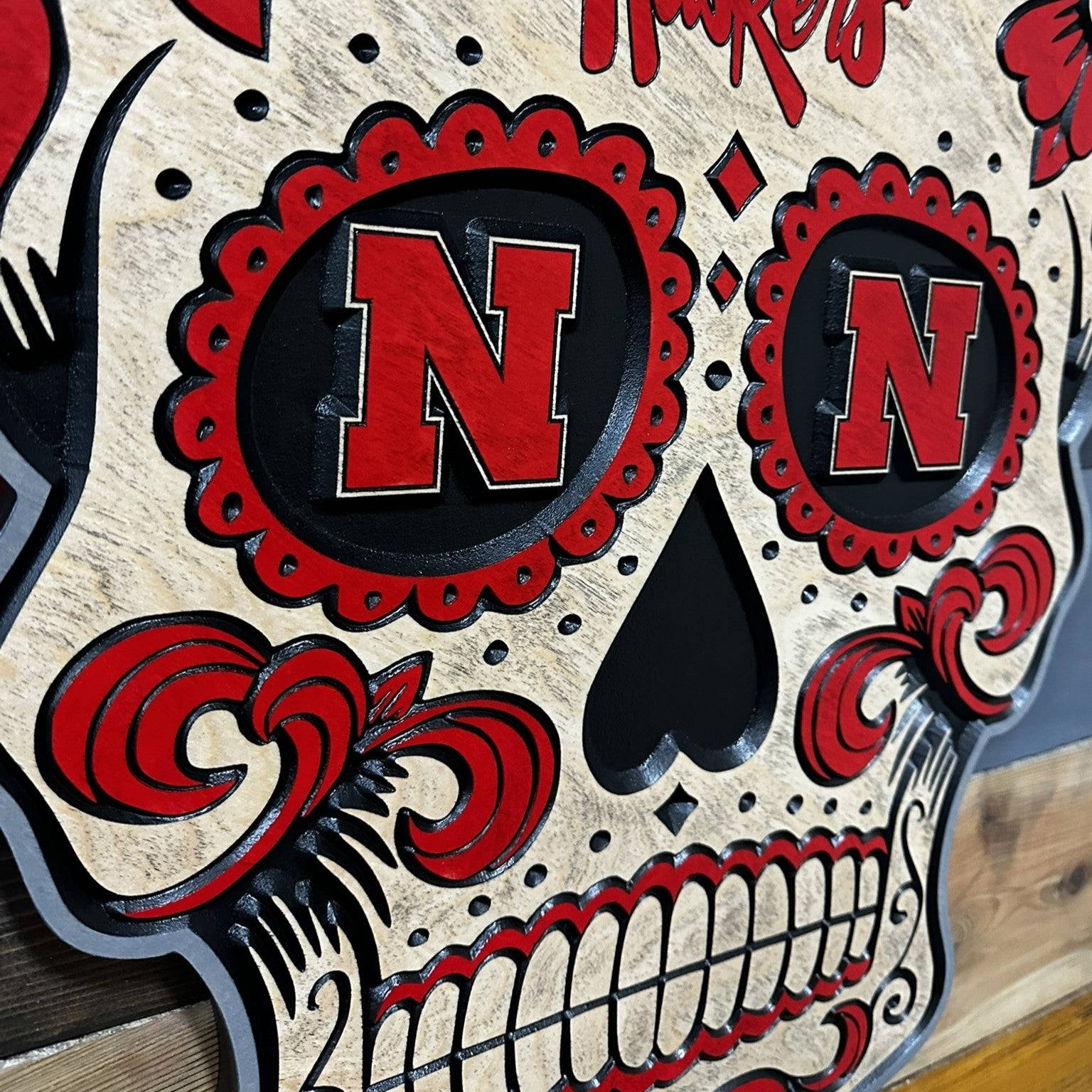 Side profile of Huskers sugar skull wood sign
