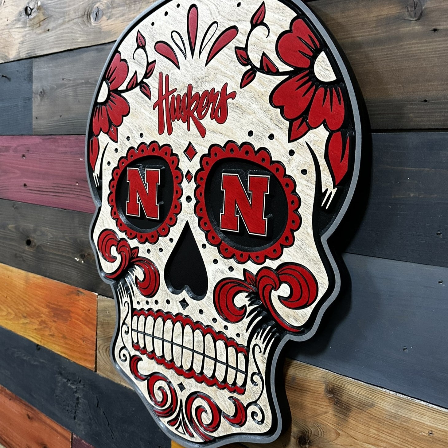 Huskers sugar skull wood sign displayed on wall