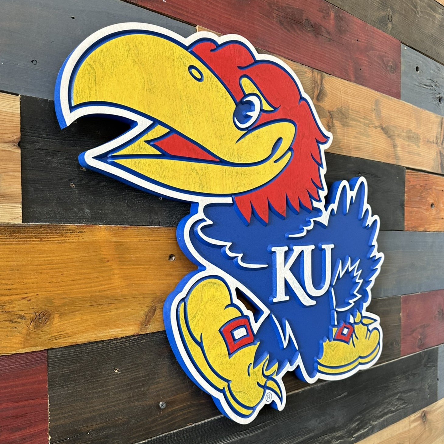Close view of Kansas Big Jay mascot carved wood sign