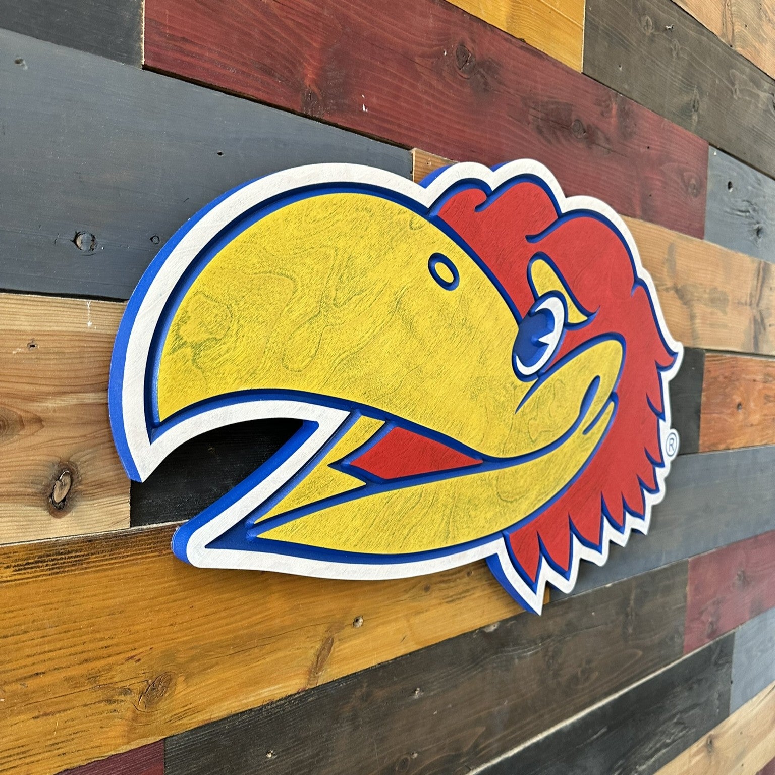 Close view of Kansas Big Jay mascot head carved wood sign