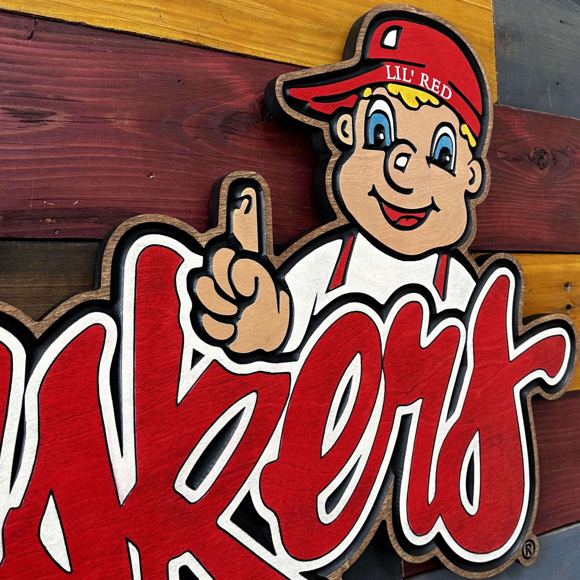 Side profile of Lil’ Red cursive Huskers sports wood art