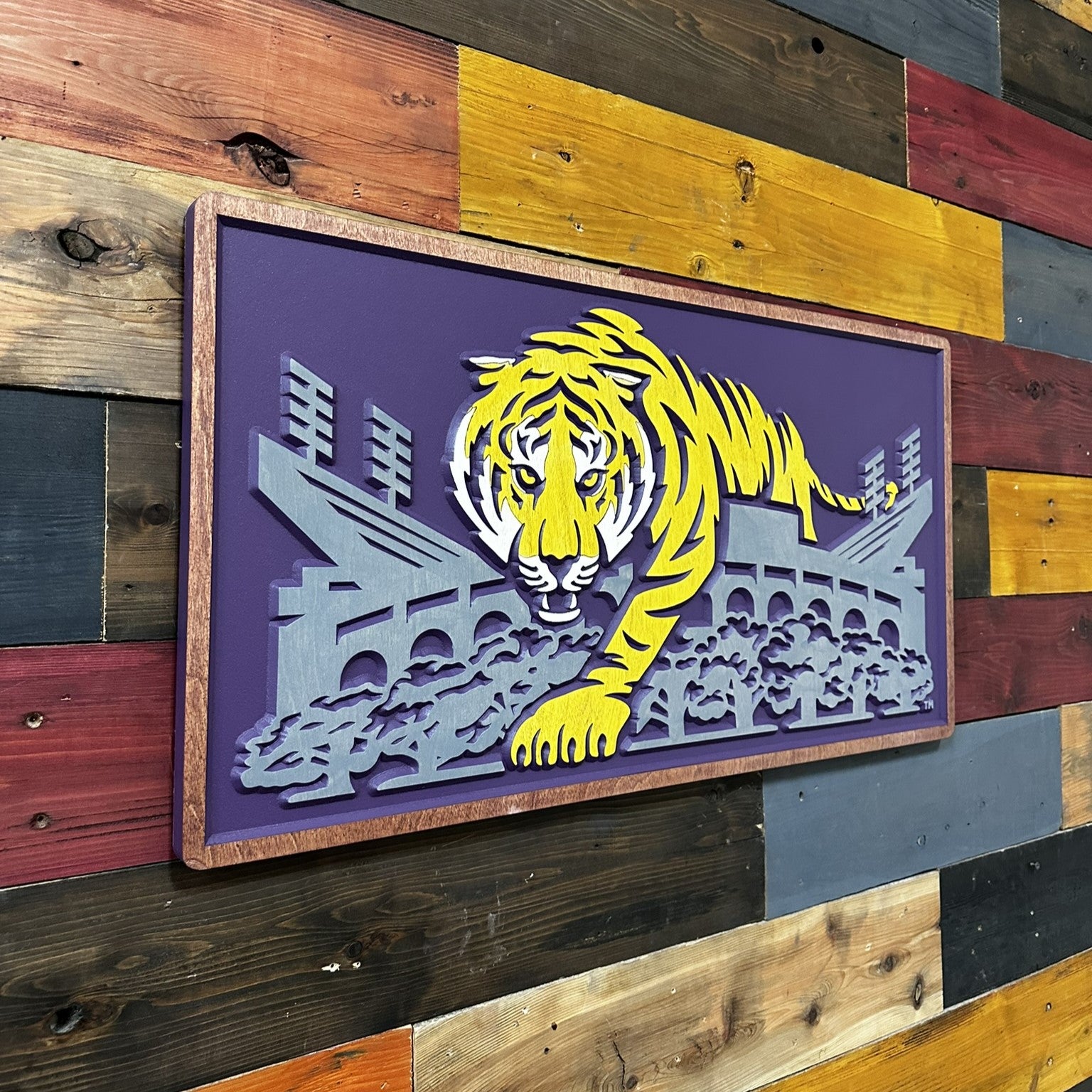 Wooden wall art with a yellow tiger design on a purple background