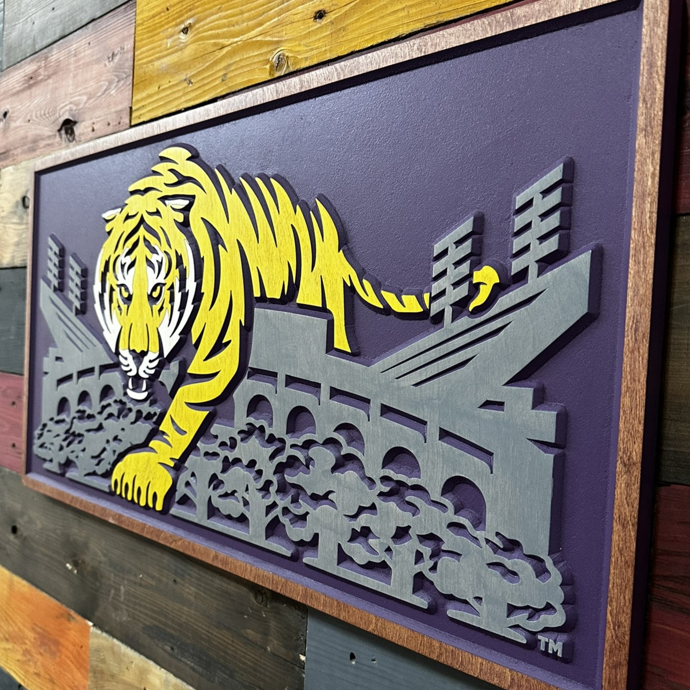 Close up detail of LSU Mike the Tiger artwork featuring layered carved tiger stripes and Tiger Stadium architectural detail