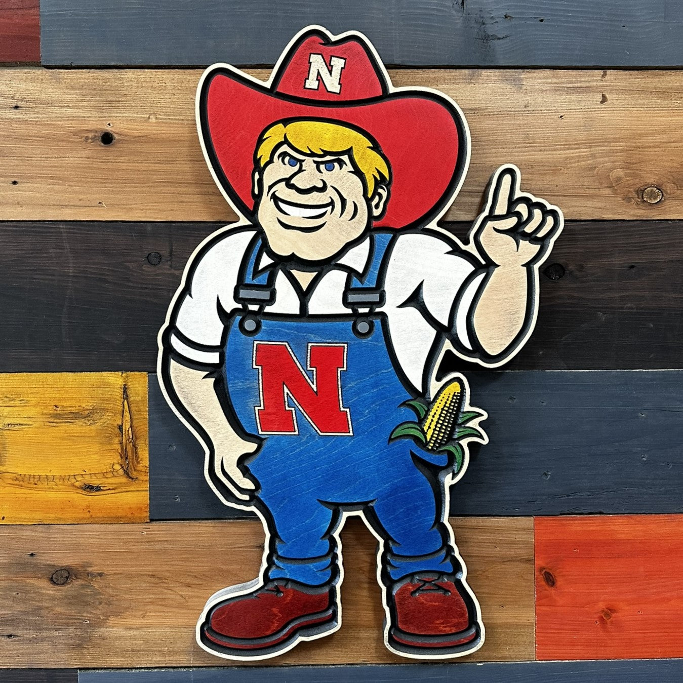 Close-up of carved Nebraska Cornhuskers Herbie Husker wood sign detail