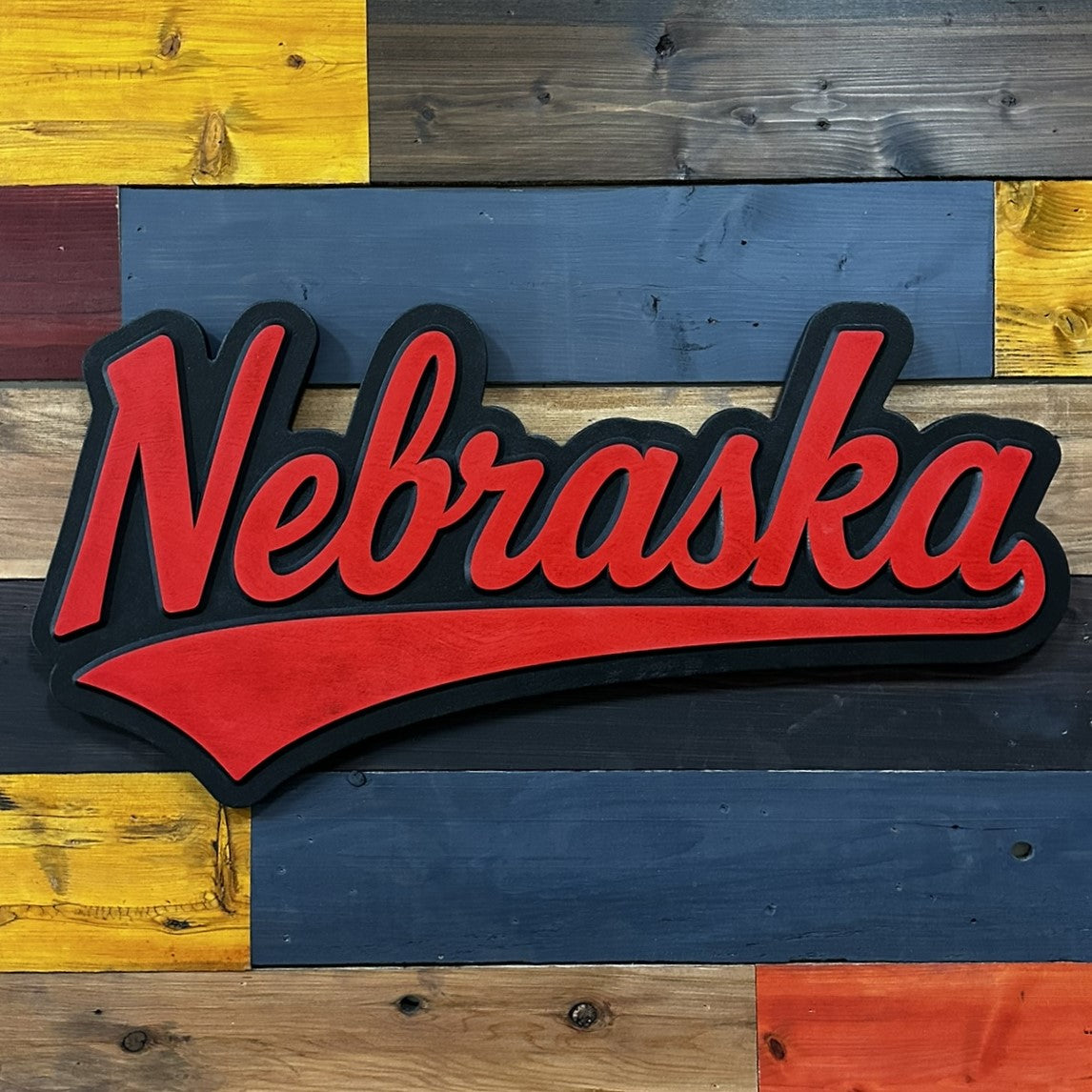 Angled view of Nebraska Cornhuskers jersey font wood sign