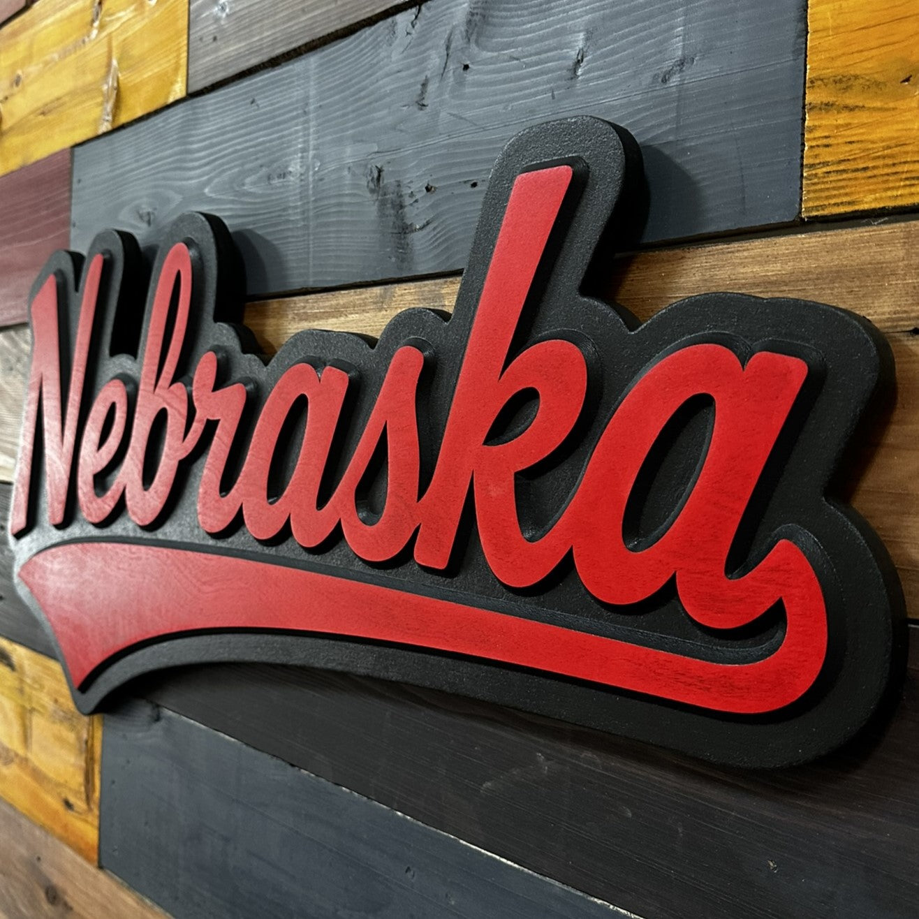 Nebraska Cornhuskers jersey font wood sign displayed on wall