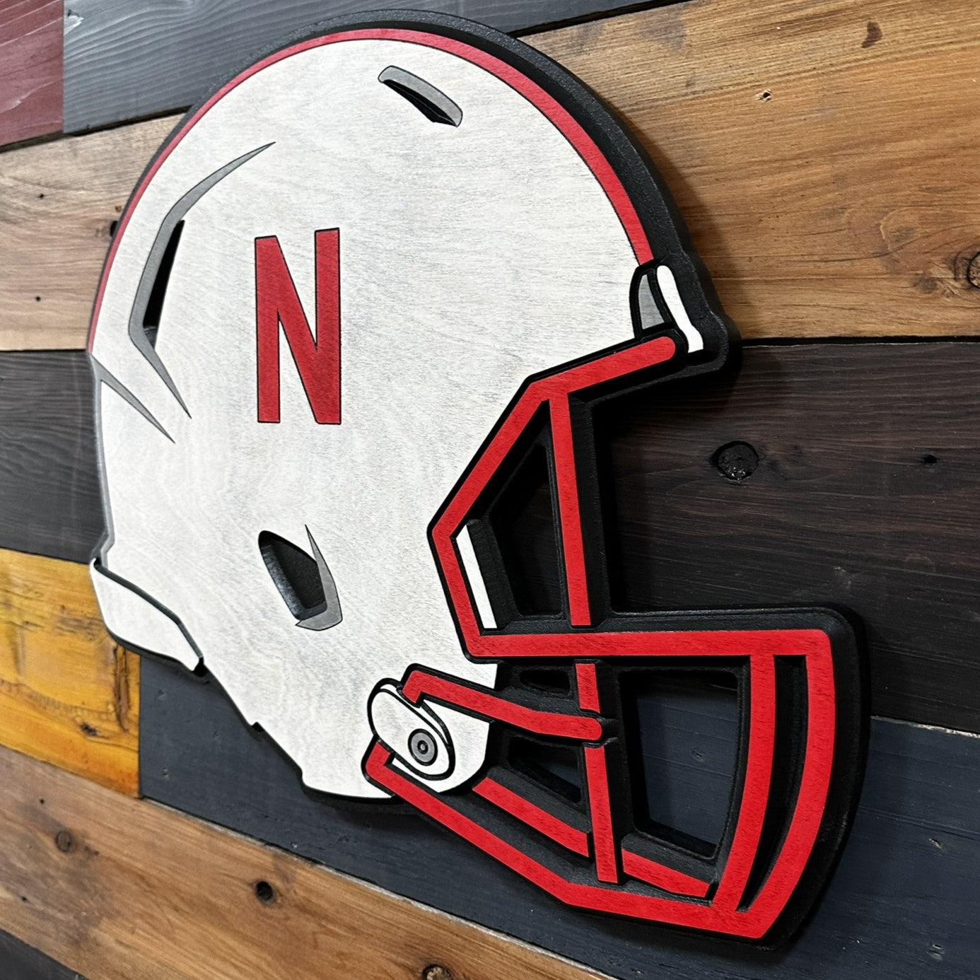 Angled view of Nebraska helmet wood sign
