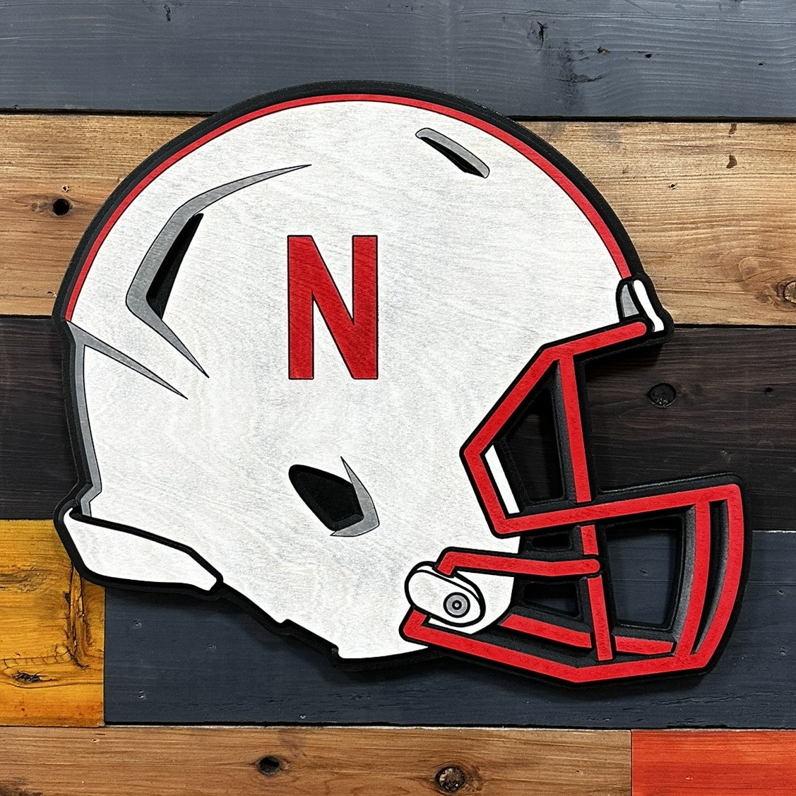 Close-up of carved Nebraska helmet wood sign detail
