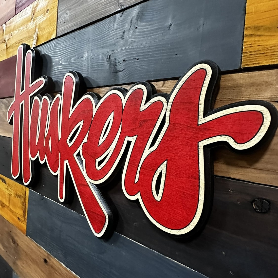 Nebraska Huskers red script 3D wood sign displayed on wall