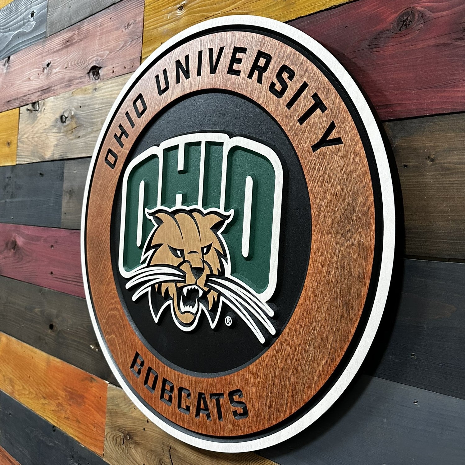 Detailed close up of the Ohio Bobcats mascot logo with carved layered features and painted dimensional outlines