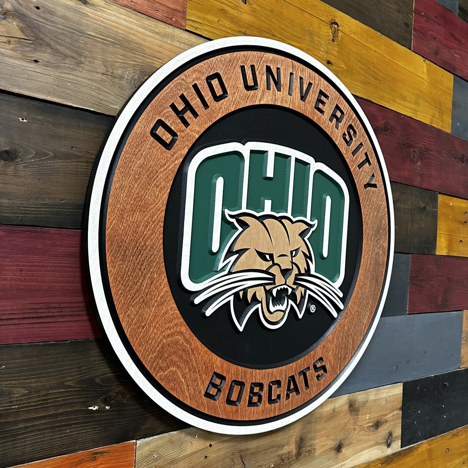 Side profile of Ohio University round carved wood sign highlighting layered construction and beveled dimensional depth