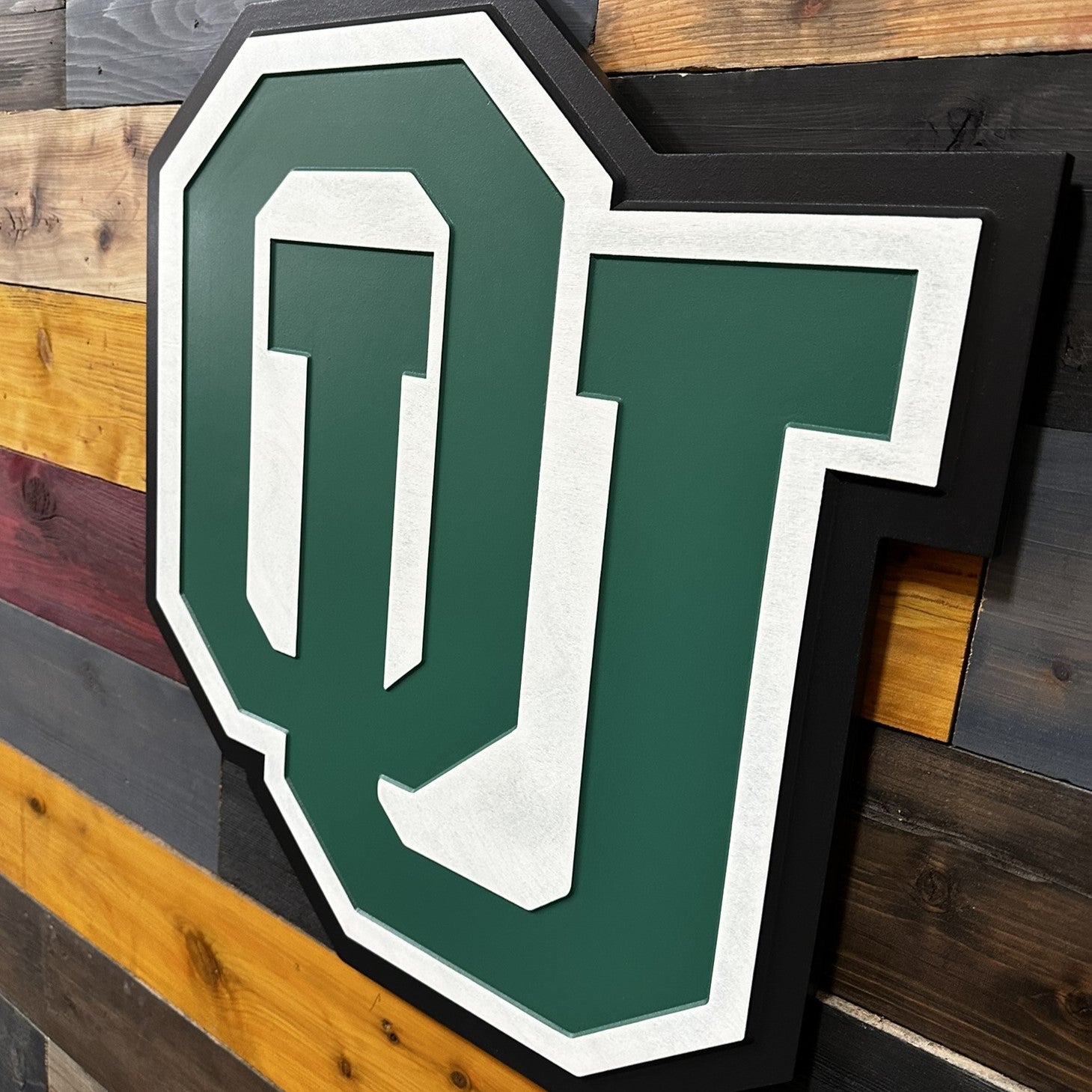 Close up detail of Ohio University OU carved lettering featuring layered paint lines and crisp beveled edges