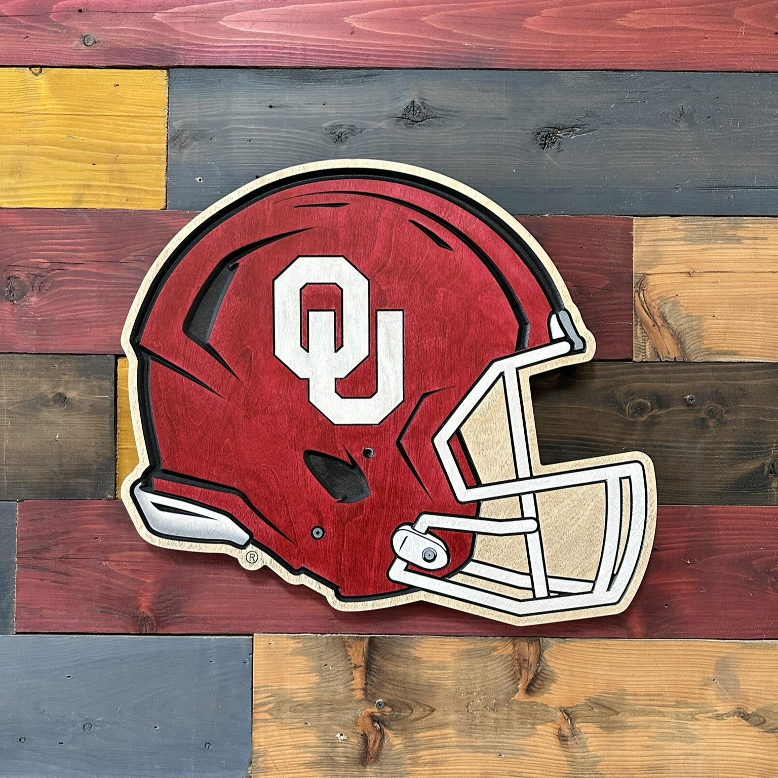 Close-up of the carved details and beveled edges on the Oklahoma Sooners helmet wood wall art.