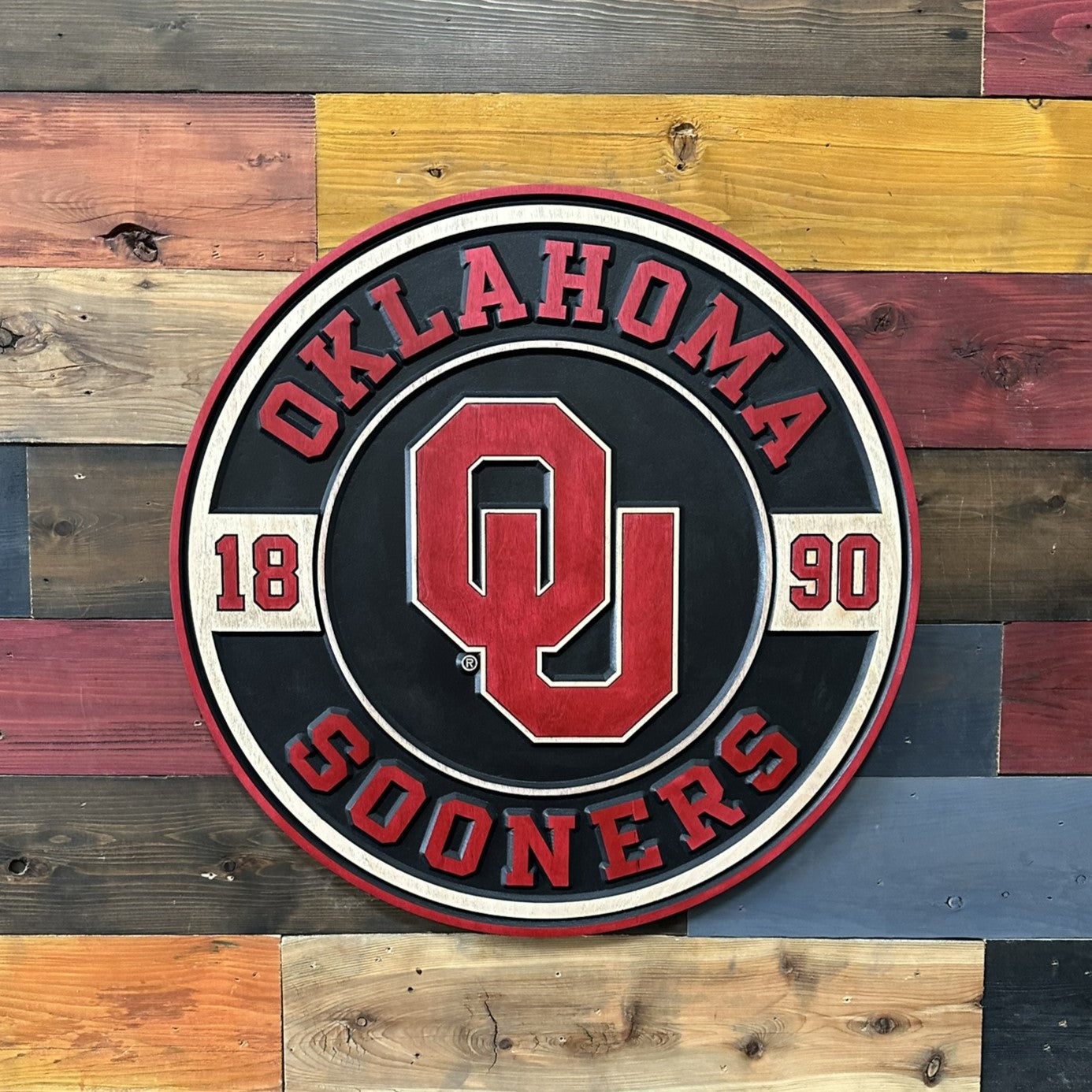 Handcrafted Oklahoma Sooners round wood sign featuring the official OU logo and 1890 heritage design