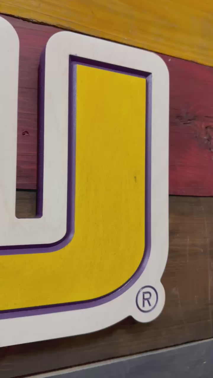 Video showcasing handcrafted horizontal LSU logo wall art with layered carving depth and dimensional purple and gold detail