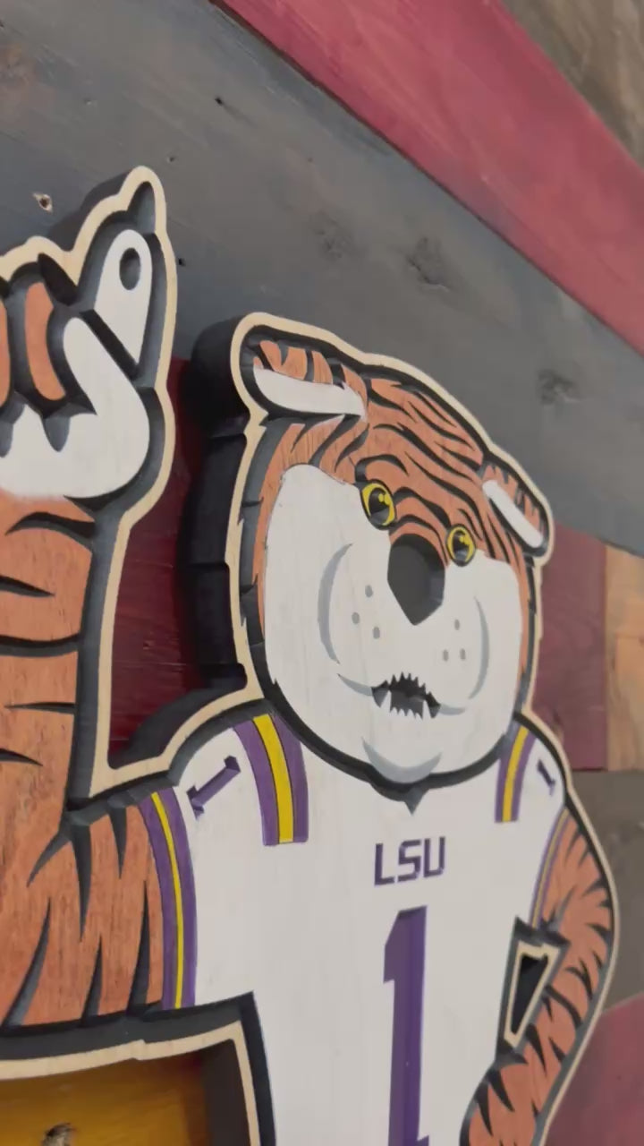 Take a closer look at our officially licensed LSU Mike the Tiger Football Wood Sign. Precision CNC carved, hand-painted, and handcrafted in Nebraska, this unique wall art features Mike the Tiger wearing an LSU football jersey and is perfect for LSU football fans, alumni, and collectors.